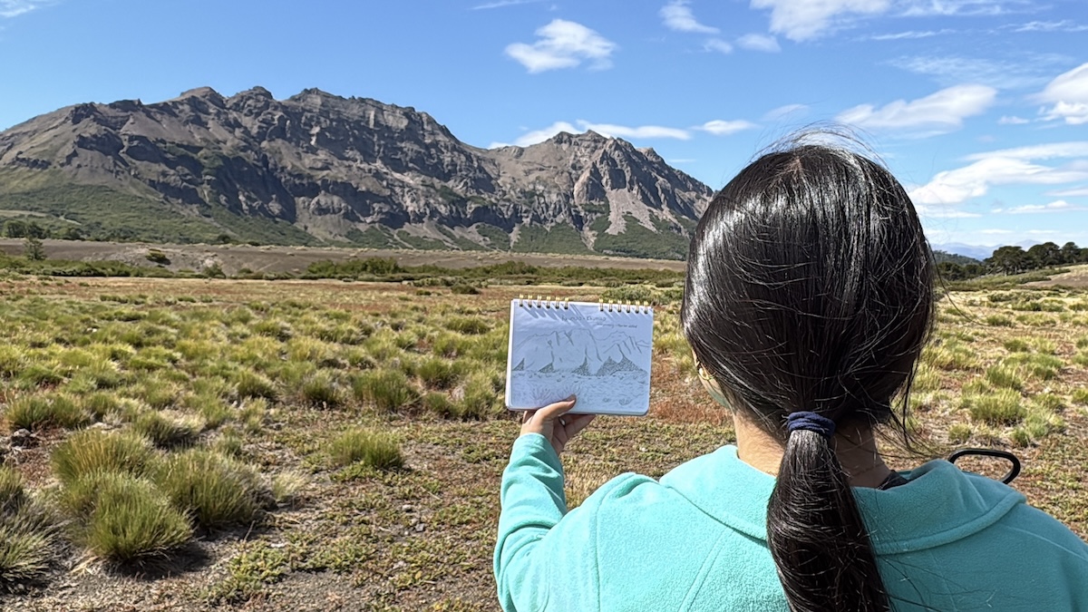 A student showing a picture she has drawn in Chile