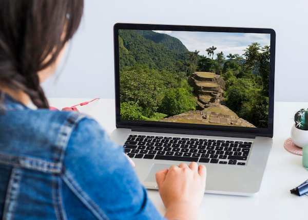 Woman using a computer with a Lost City on the screen