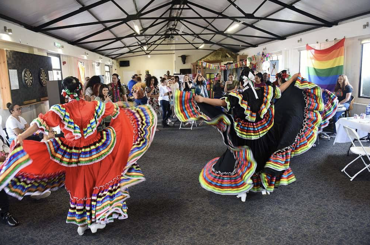 Celebrating Hispanic Heritage Month with women dancing in colourful dresses
