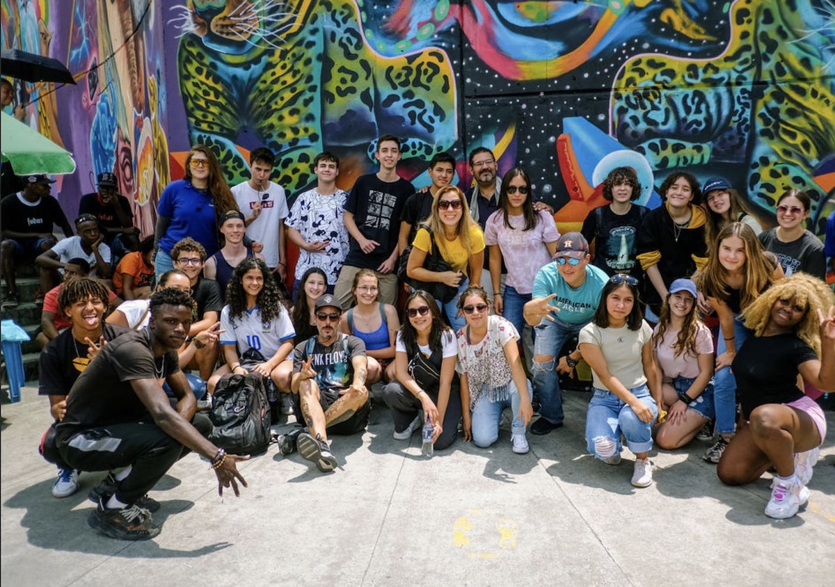 Students crouching and smiling in Comuna 13