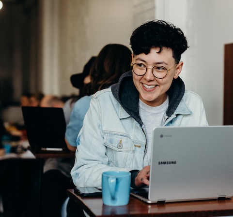 Young man in glasses using a computer