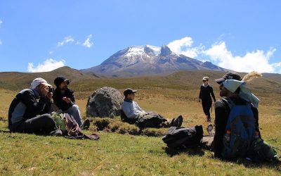 men sitting in front of colombia mountain