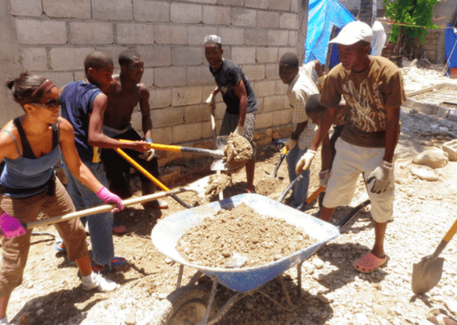 people shovelling soil