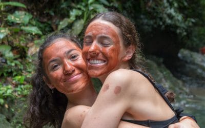 Two girls with painted faces smiling on a school trip