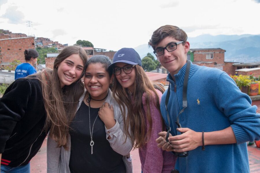students smiling with medellin local