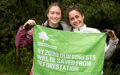 two girls holding up an sdg flag