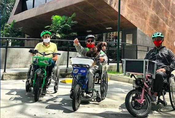 Three people in bikes for people with disabilities