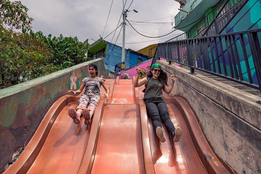 women sliding down a slide